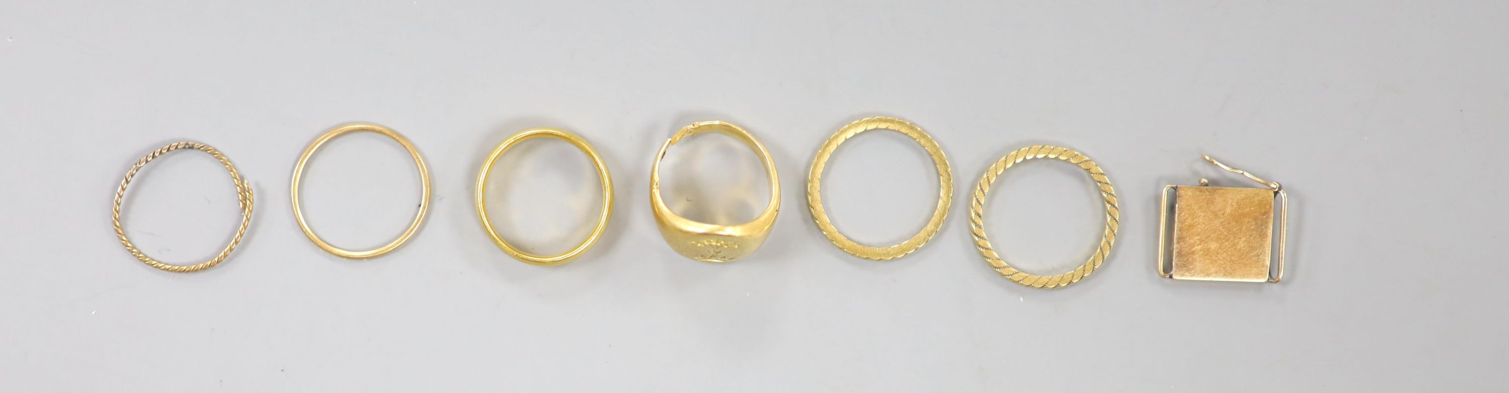 A George V 22ct gold wedding band, 5 grams, a yellow metal signet ring(cut) 8.2 grams and five other items.